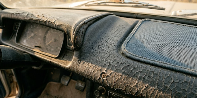 Close-up of cracked dashboard plastic from years of summer heat exposure