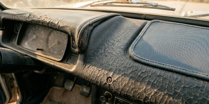 Close-up of cracked dashboard plastic from years of summer heat exposure